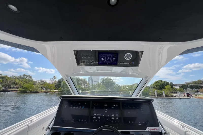 Slide: The Image of Interior view of 2025 Cigarette 41 Nighthawk boat dashboard with digital displays. - 27