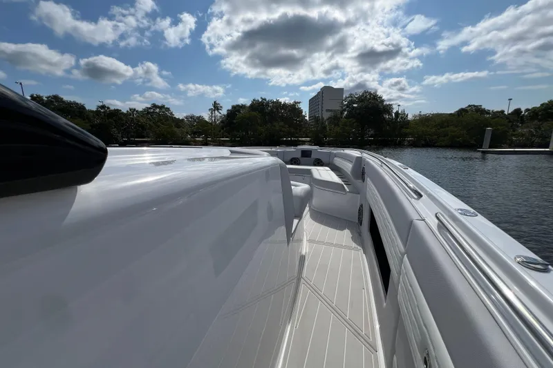 Slide: The Image of 2025 Cigarette 41 Nighthawk boat deck under a partly cloudy sky. - 28