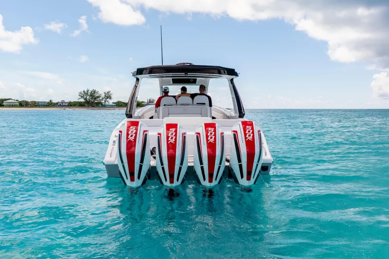 Slide: The Image of 2025 Cigarette 41 Nighthawk boat with four powerful engines on clear blue water. - 3