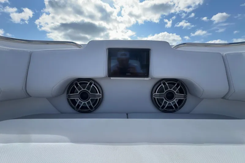 Slide: The Image of 2025 Cigarette 41 Nighthawk boat interior with speakers and display screen under blue sky. - 31