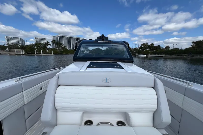 Slide: The Image of 2025 Cigarette 41 Nighthawk boat on calm water, modern design, blue sky background. - 34