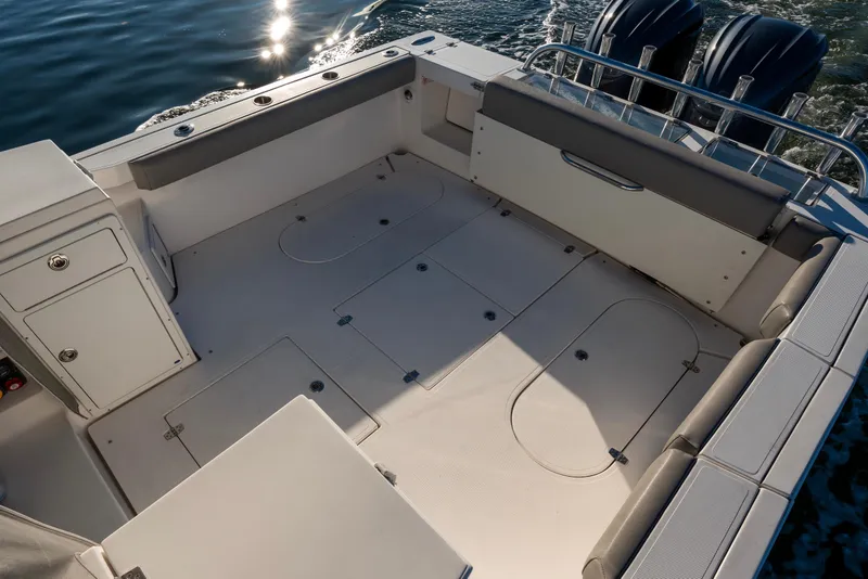 Slide: The Image of 2021 NorthCoast 315 HT boat deck with storage compartments and seating. - 12