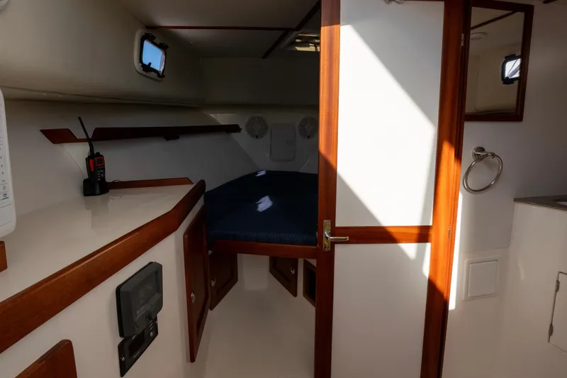 Slide: The Image of Interior of 2021 NorthCoast 315 HT boat, featuring cozy cabin and wooden accents. - 13