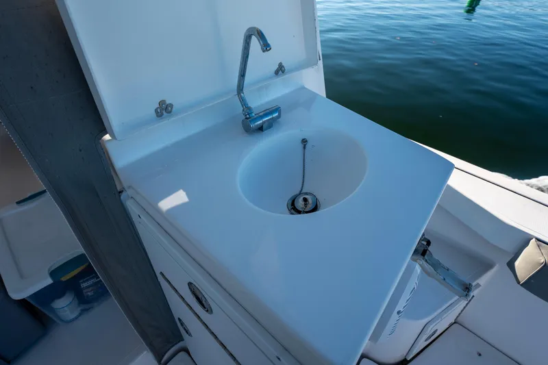 Slide: The Image of 2021 NorthCoast 315 HT boat sink with faucet, docked on calm water. - 15