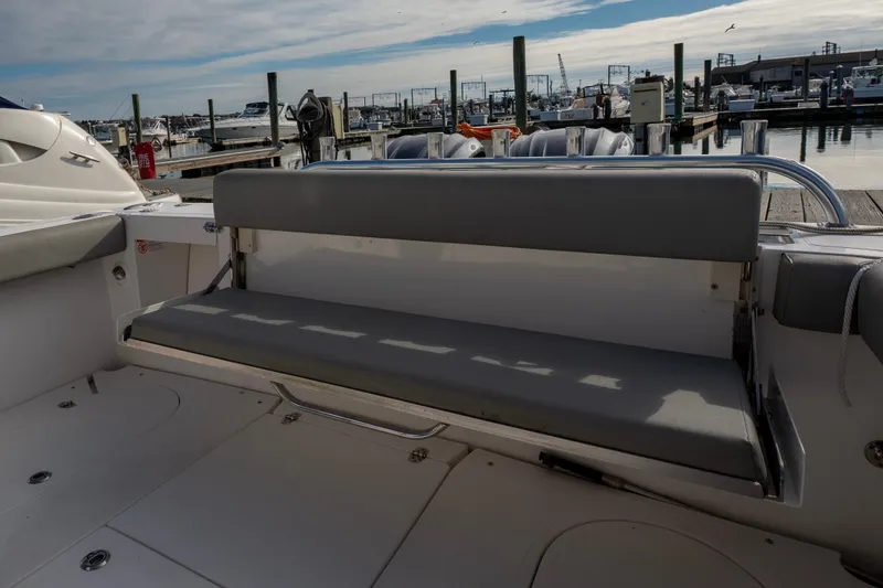 Slide: The Image of 2021 NorthCoast 315 HT boat with gray seating at a marina dock. - 18