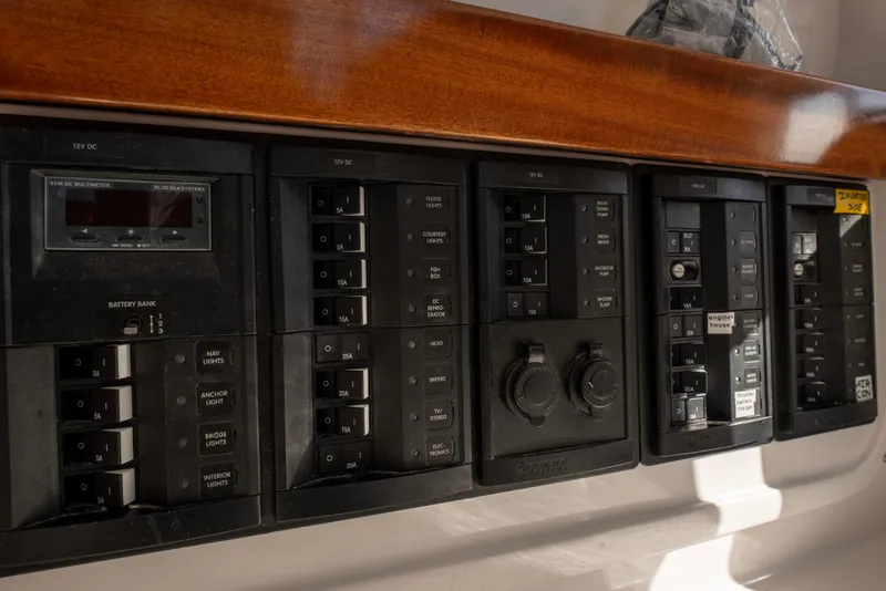 Slide: The Image of Control panel of a 2021 NorthCoast 315 HT boat with various switches and meters. - 21