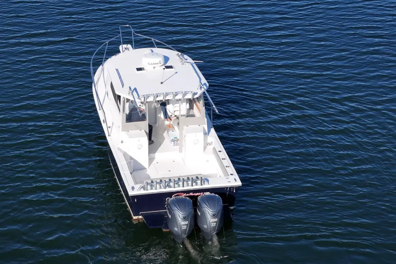 Slide: The Image of 2021 NorthCoast 315 HT boat with dual engines on calm water. - 27