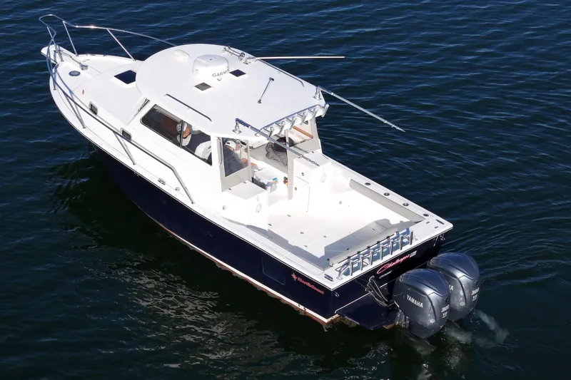 Slide: The Image of 2021 NorthCoast 315 HT boat with dual Yamaha engines on calm water. - 28