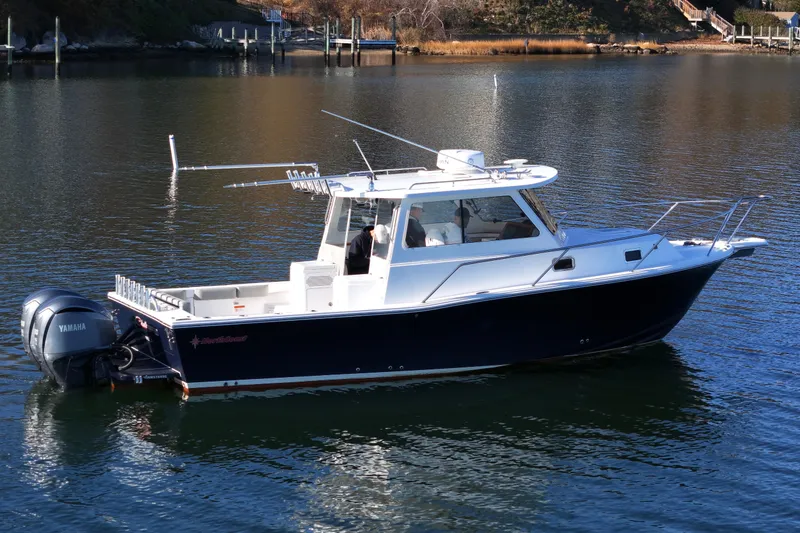 Slide: The Image of 2021 NorthCoast 315 HT boat on calm water, featuring Yamaha outboard motor. - 34