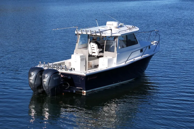 Slide: The Image of 2021 NorthCoast 315 HT boat with dual Yamaha engines on calm water. - 35