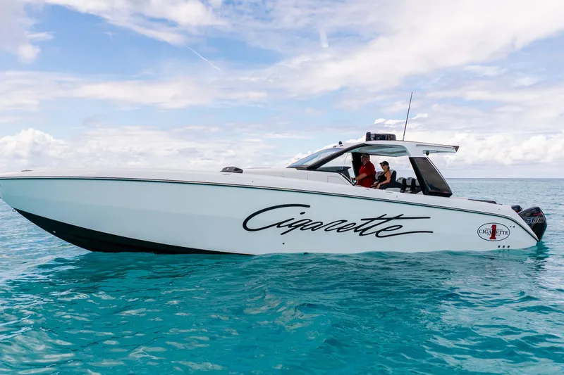 The Image of 2025 Cigarette 42 Auroris boat cruising on clear blue water under a partly cloudy sky. - 0