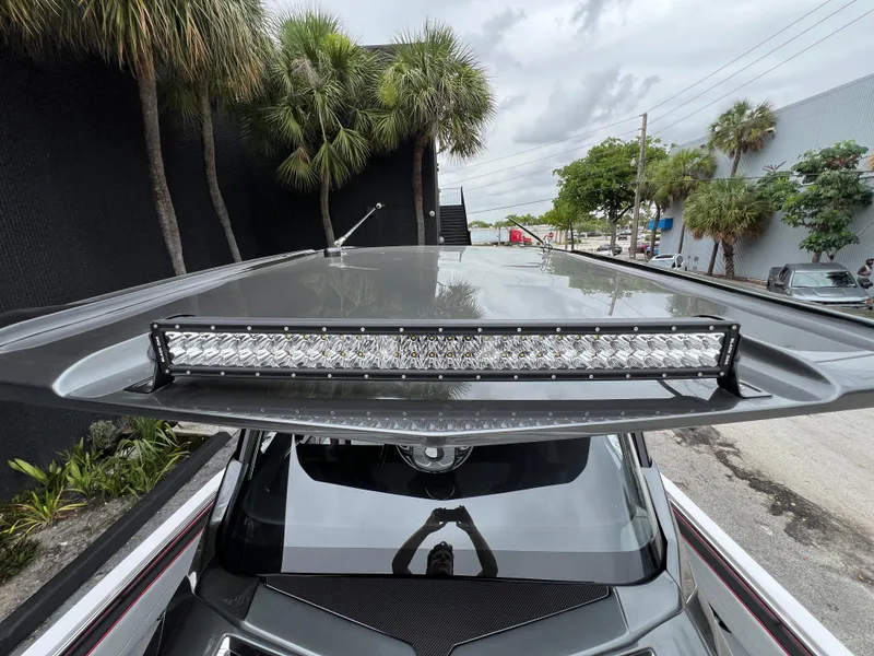 Slide: The Image of 2025 Nor-Tech 400 Supersport with sleek roof and LED light bar, surrounded by palm trees. - 26