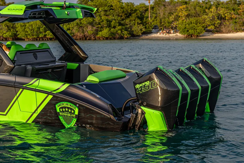 Slide: The Image of 2024 Adrenaline Reaper boat with vibrant green accents and powerful engines on a serene water backdrop. - 3