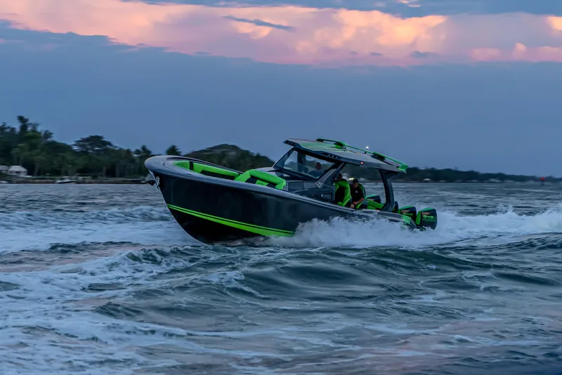 Slide: The Image of 2024 Adrenaline Reaper boat cruising on choppy waters at sunset. - 8