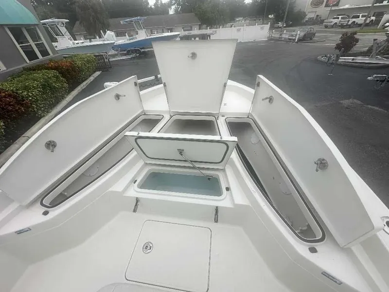 Slide: The Image of 2019 Ranger 2510 Bay Ranger boat with open storage compartments. - 9
