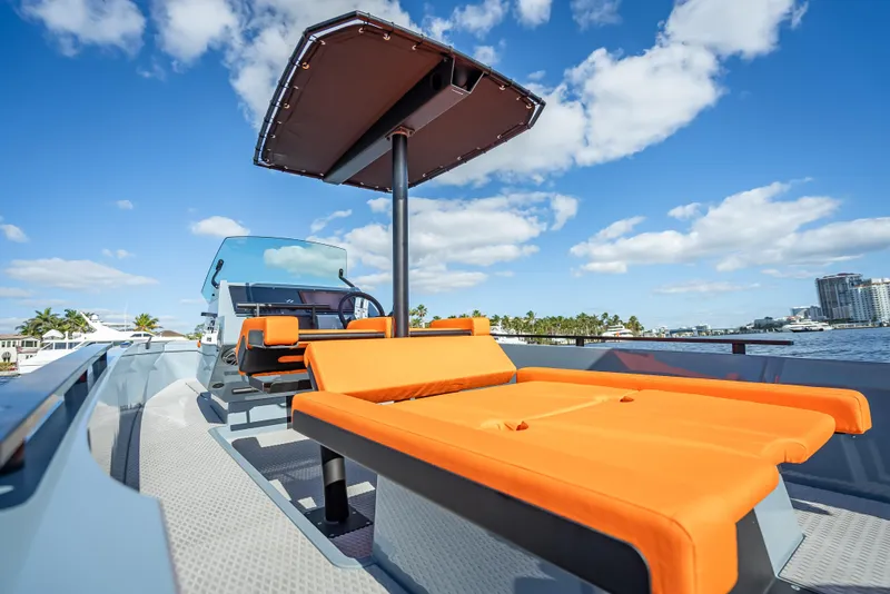 Slide: The Image of 2024 Goldfish 28 Tender with orange seating and canopy on a sunny day. - 14