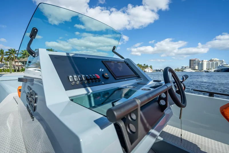 Slide: The Image of Control panel of 2024 Goldfish 28 Tender boat with scenic waterfront view. - 19