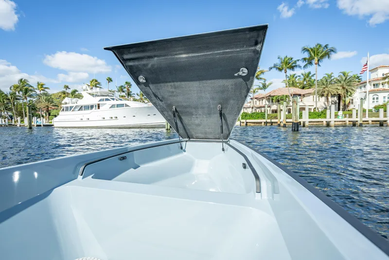 Slide: The Image of 2024 Goldfish 28 Tender boat with open storage compartment on a sunny day. - 22