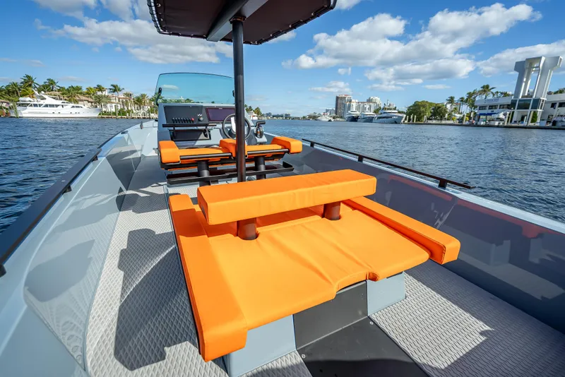 Slide: The Image of 2024 Goldfish 28 Tender boat with orange seating on a sunny day. - 4
