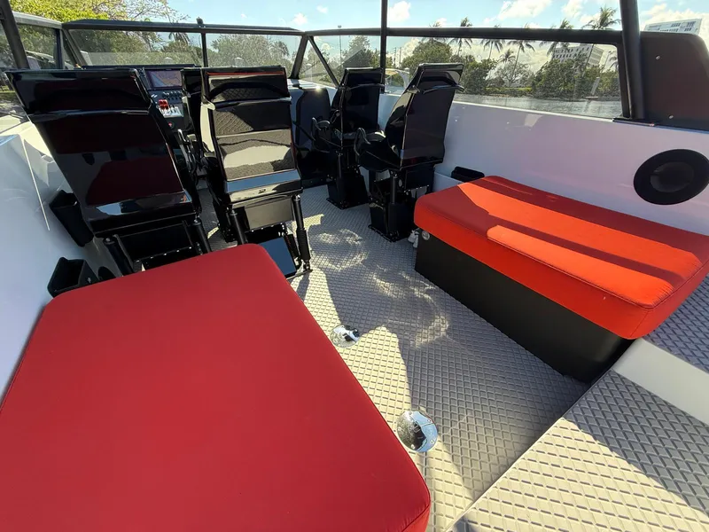 Slide: The Image of 2024 Goldfish 46 Open boat interior with red seating and modern design. - 11