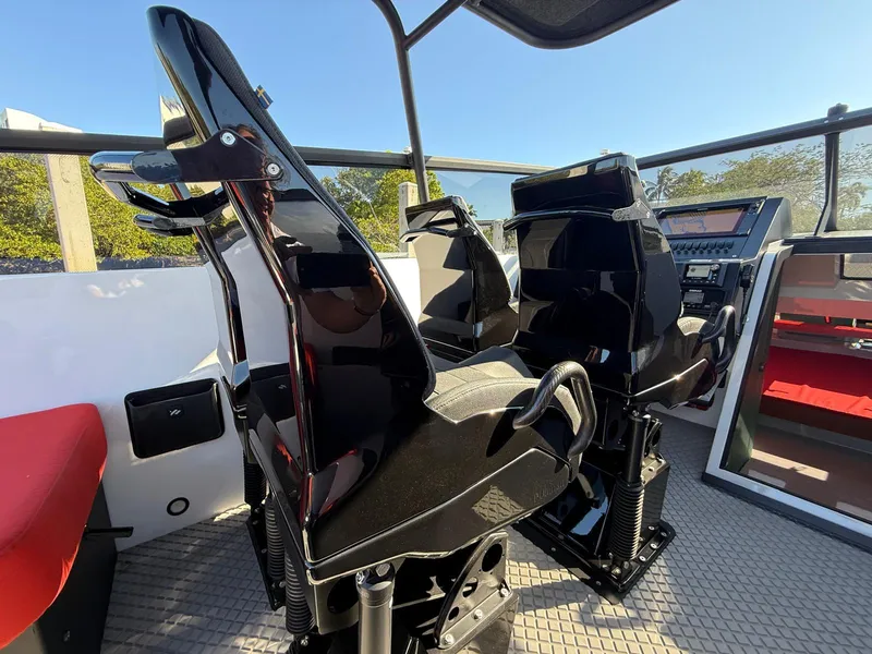 Slide: The Image of 2024 Goldfish 46 Open boat interior with sleek black seats and modern dashboard. - 14