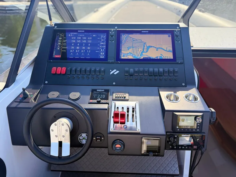 Slide: The Image of 2024 Goldfish 46 Open boat dashboard with navigation screens and controls. - 15