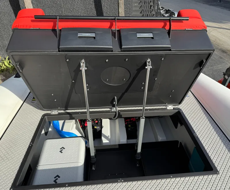 Slide: The Image of Open storage compartment on 2024 Goldfish 46 Open boat with red seating. - 19