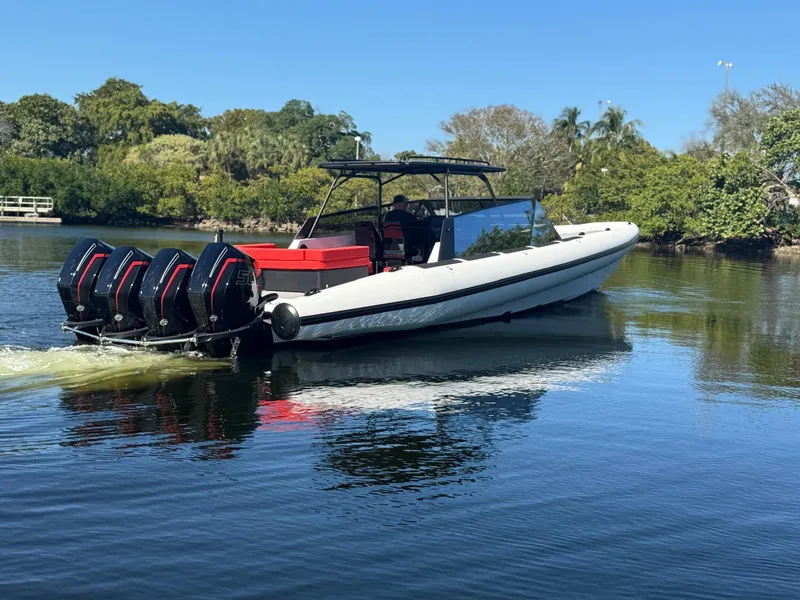 Slide: The Image of 2024 Goldfish 46 Open boat with four engines cruising on a calm lake. - 3