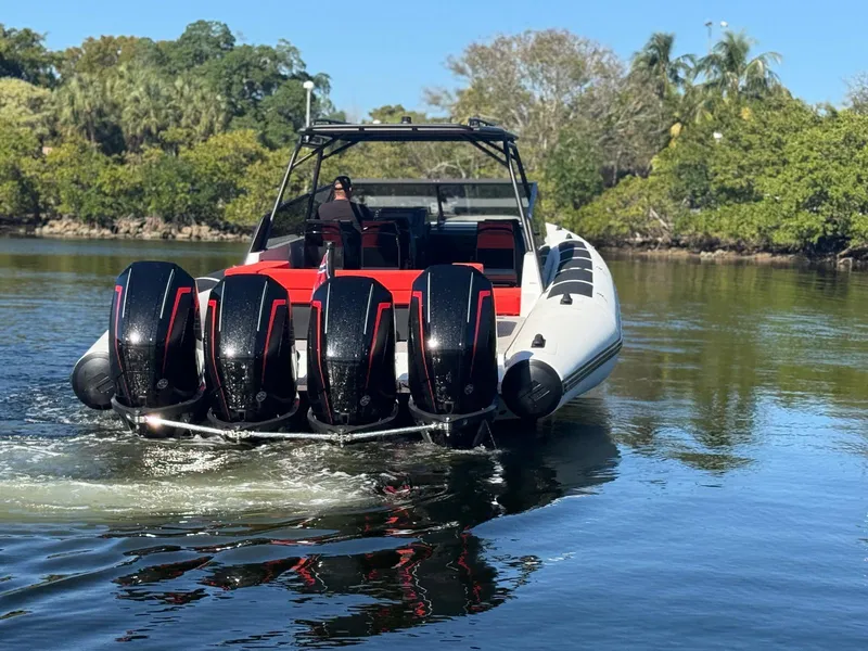 Slide: The Image of 2024 Goldfish 46 Open boat with four powerful outboard engines on a serene waterway. - 4