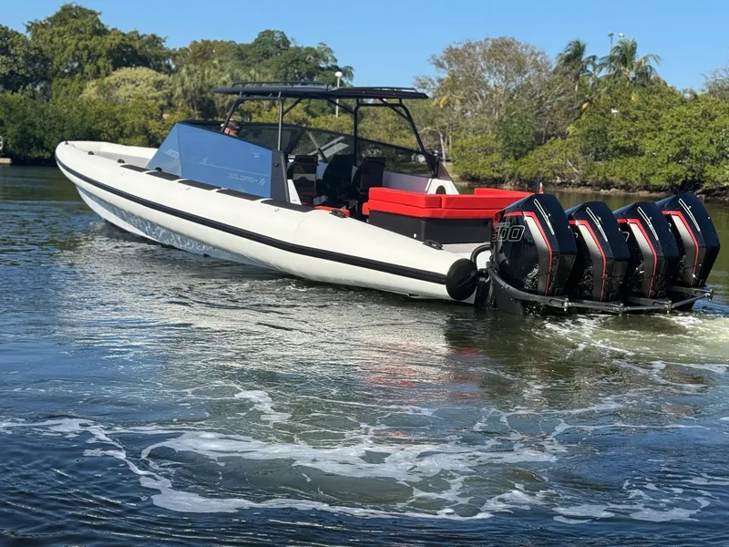 Slide: The Image of 2024 Goldfish 46 Open boat with triple engines on a calm waterway. - 5