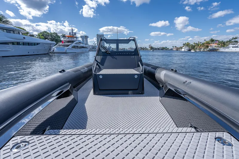 Slide: The Image of 2024 Goldfish X10 Scout boat on water with yachts in the background. - 12
