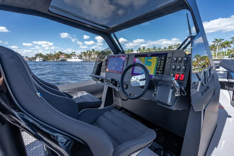 Slide: The Image of 2024 Goldfish X10 Scout boat cockpit with advanced navigation system and dual seats. - 13