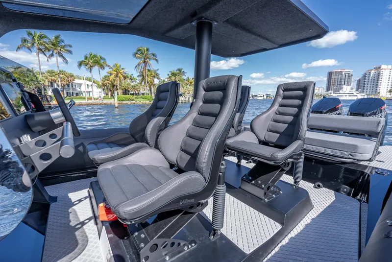 Slide: The Image of Interior seating of 2024 Goldfish X10 Scout boat with waterfront view. - 15