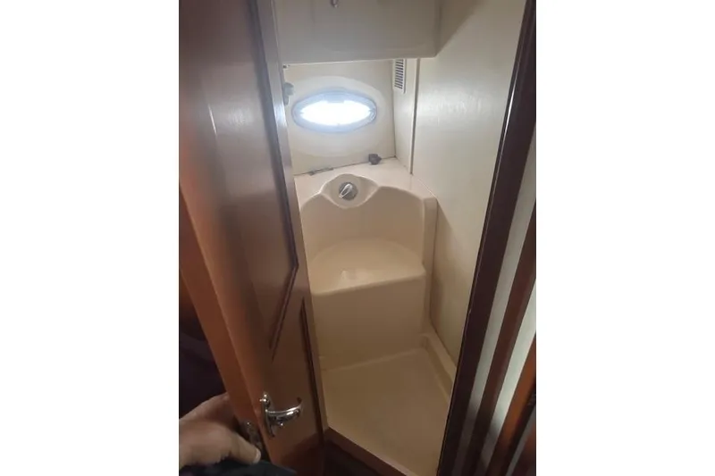 Slide: The Image of 2008 Silverton 36 Convertible yacht bathroom with shower and porthole window. - 12