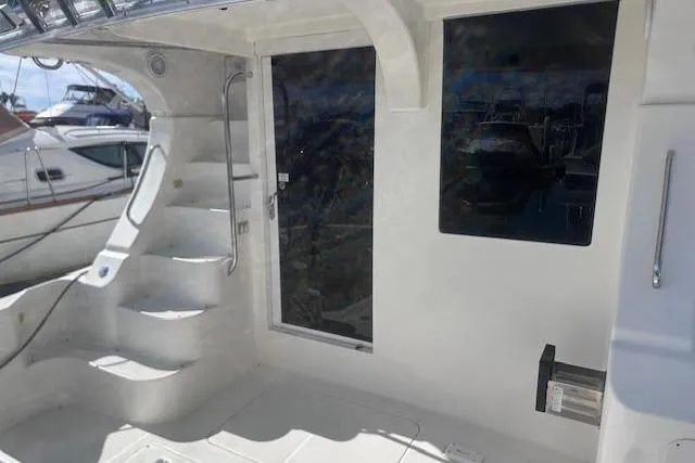 Slide: The Image of 2008 Silverton 36 Convertible yacht with white exterior and staircase. - 15
