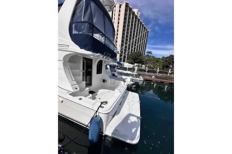 Slide: The Image of 2008 Silverton 36 Convertible yacht docked near waterfront building. - 3