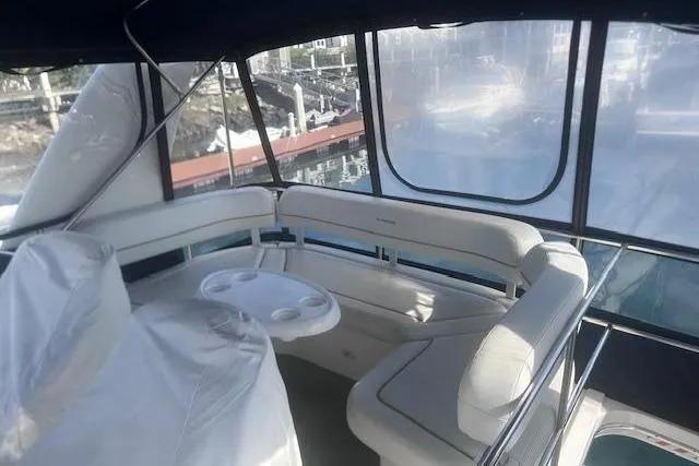 Slide: The Image of 2008 Silverton 36 Convertible yacht interior with white seating and table. - 4