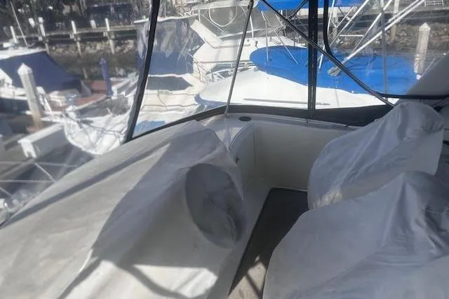 Slide: The Image of 2008 Silverton 36 Convertible boat interior with covered seating at marina. - 5