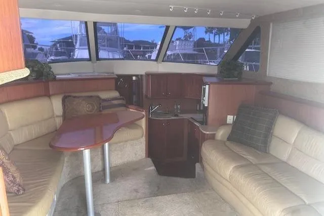 Slide: The Image of Interior of 2008 Silverton 36 Convertible yacht with plush seating and wooden cabinetry. - 6