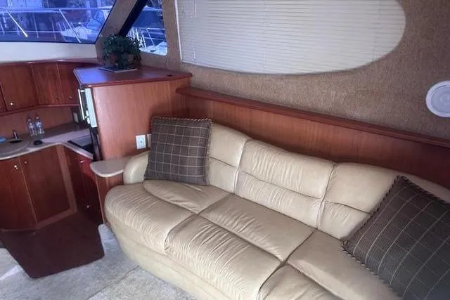 Slide: The Image of Luxurious interior of 2008 Silverton 36 Convertible yacht with beige leather sofa and wooden cabinetry. - 7