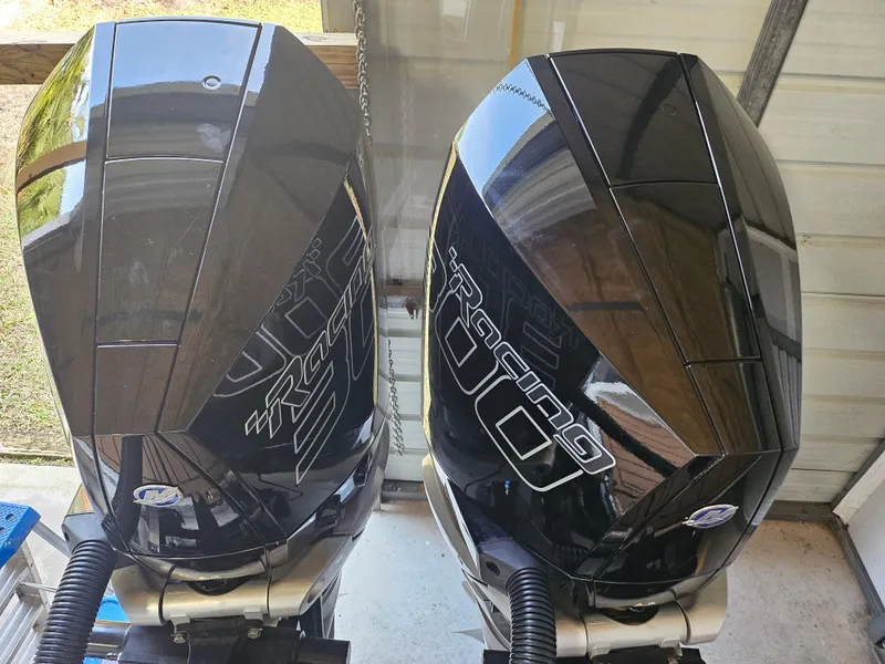 Slide: The Image of Two black Statement 350 Open outboard motors, 2021 model, in a garage setting. - 10
