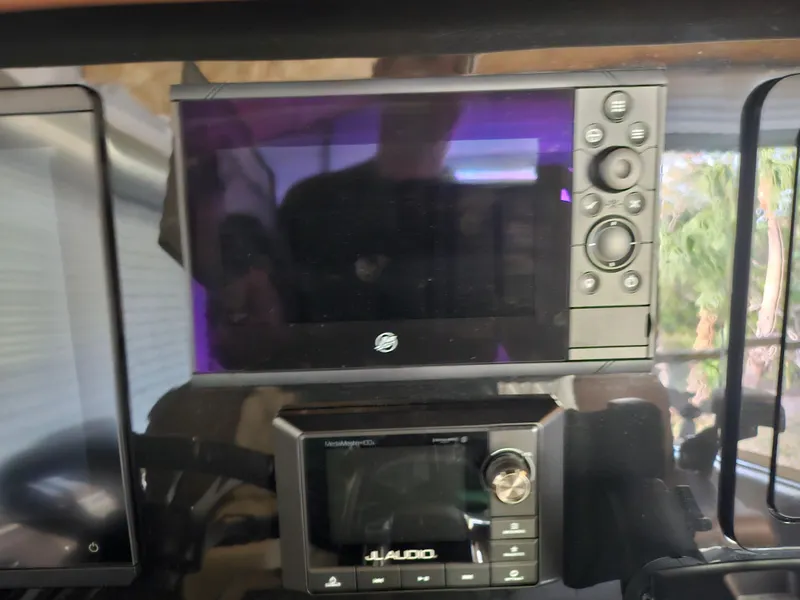 Slide: The Image of Control panel of a 2021 Statement 350 Open boat with electronic displays. - 13