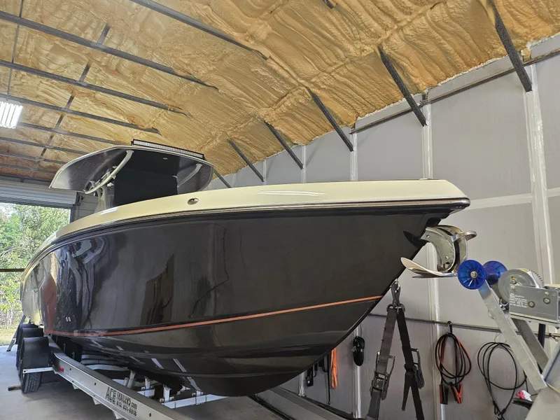 Slide: The Image of 2021 Statement 350 Open boat on trailer in a garage. - 2