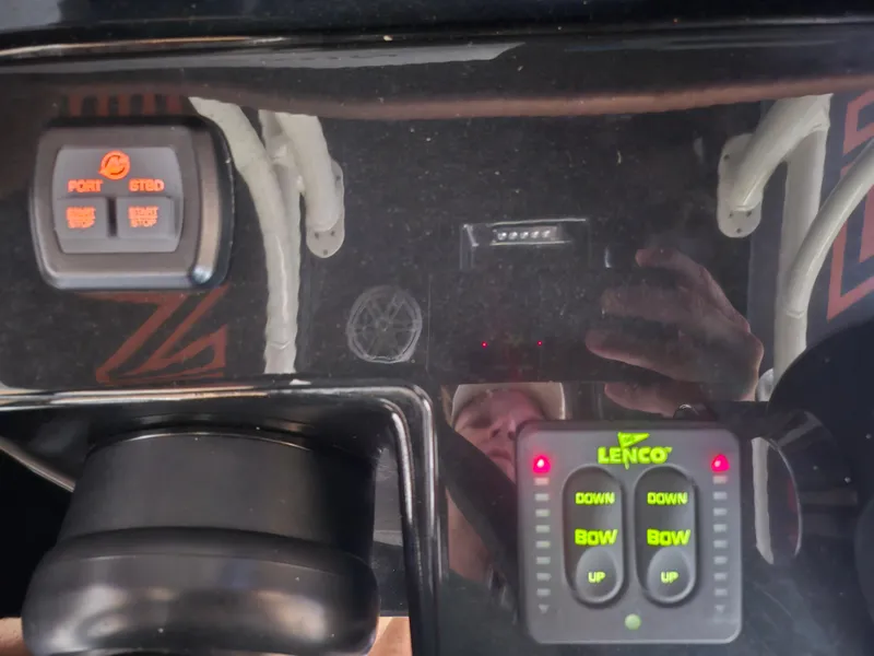 Slide: The Image of Control panel of a 2021 Statement 350 Open boat with Lenco trim tab switches. - 22
