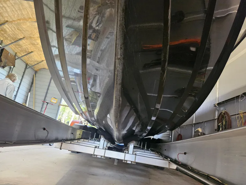 Slide: The Image of 2021 Statement 350 Open boat hull in a workshop setting. - 32