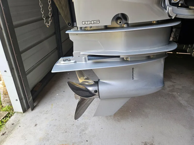 Slide: The Image of 2021 Statement 350 Open boat engine propeller in a garage. - 34