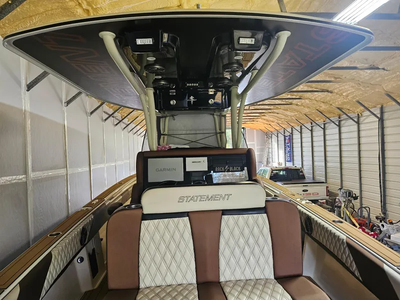 Slide: The Image of 2021 Statement 350 Open boat interior with seating and electronics in a storage facility. - 5