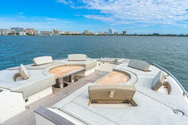 Slide: The Image of Luxurious 2018 Monte Carlo Yachts MCY 70 with spacious deck seating and scenic waterfront view. - 19