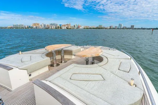 Slide: The Image of Monte Carlo Yachts MCY 70, 2018 model, luxurious deck with seating, ocean view. - 24