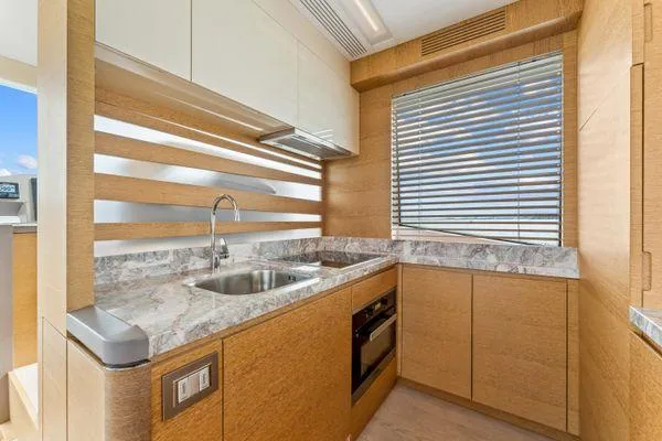 Slide: The Image of Luxurious kitchen interior of 2018 Monte Carlo Yachts MCY 70 with modern design and marble countertops. - 42